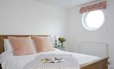 Natural daylight streams through the porthole of the double bedroom. - Thumbnail Image