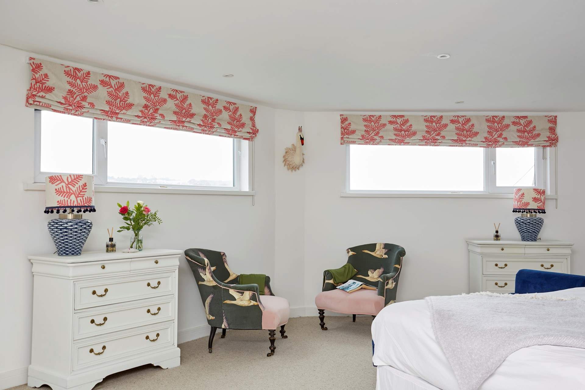 The spacious main bedroom with seating for two.