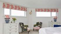 The spacious main bedroom with seating for two.