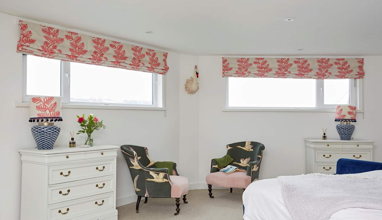 The spacious main bedroom with seating for two.