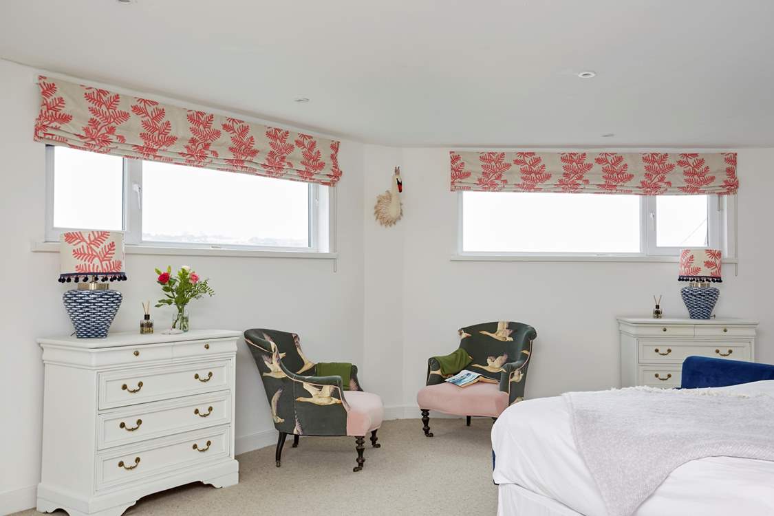 The spacious main bedroom with seating for two.