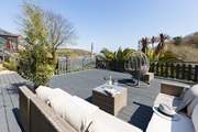 Just a few steps from the conservatory is this stunning decked area with fabulous views and comfy seating - what a dreamy location.