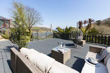 Just a few steps from the conservatory is this stunning decking with fabulous views and comfy seating - what a dreamy location.