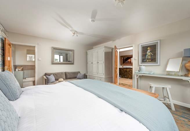 A spacious bedroom with an ensuite bathroom.