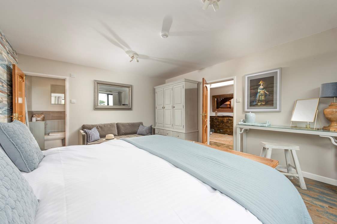 A spacious bedroom with an ensuite bathroom.