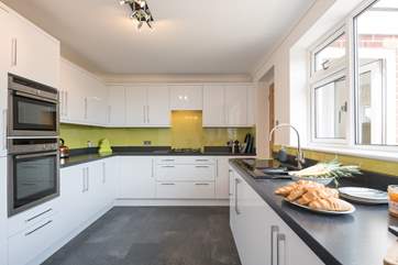 Modern kitchen with everything you could need to entertain your family and friends, you can even see the sea whilst washing the dishes!