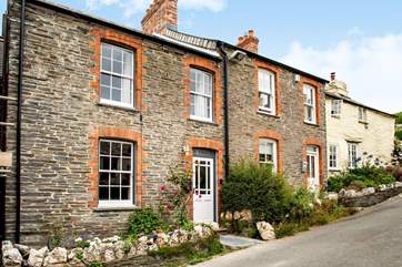 St Christopher's Cottage is to the left of the terrace of traditional Cornish cottages.
