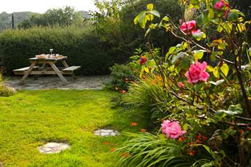 The pretty cottage garden sits at the back of the cottage, accessed up some stone steps