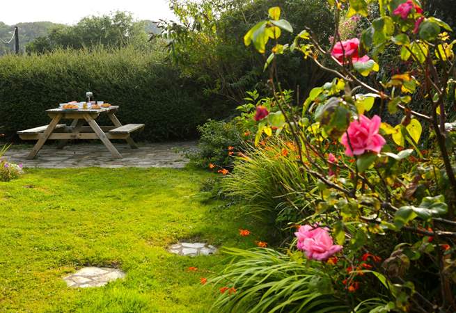 The pretty cottage garden sits at the back of the cottage, accessed up some stone steps