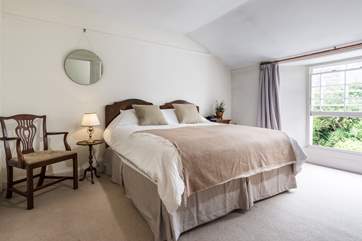 This bedroom is at the back of the house with a lush outlook over gardens (Bedroom 2).