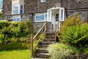 Steps lead up from the garden to the front door.