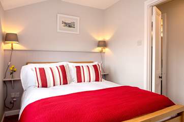 The pretty cottage bedroom sits between the sitting-room and kitchen/breakfast-room.