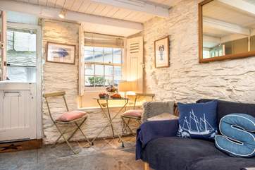 The dining-table looks out to the little lane to the side of the cottage.