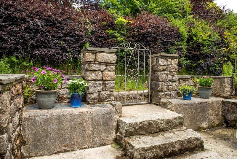 On the opposite side of the gate, three steps lead down to the entrance of Hudson Cottage.