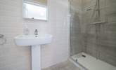 The en suite to the main bedroom has a rainfall shower, perfect after a day on the beach. - Thumbnail Image