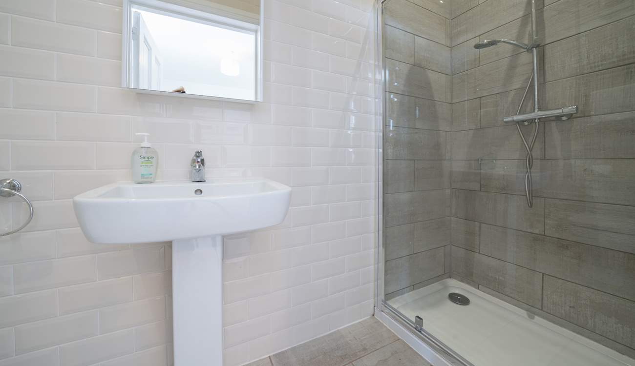 The en suite to the main bedroom has a rainfall shower, perfect after a day on the beach.