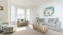 Pastel shades and comfy seating in the living area.
