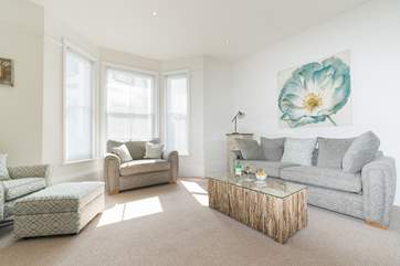 Pastel shades and comfy seating in the living-area.