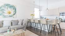 The sleek lines of the kitchen are complemented by the contemporary seating.