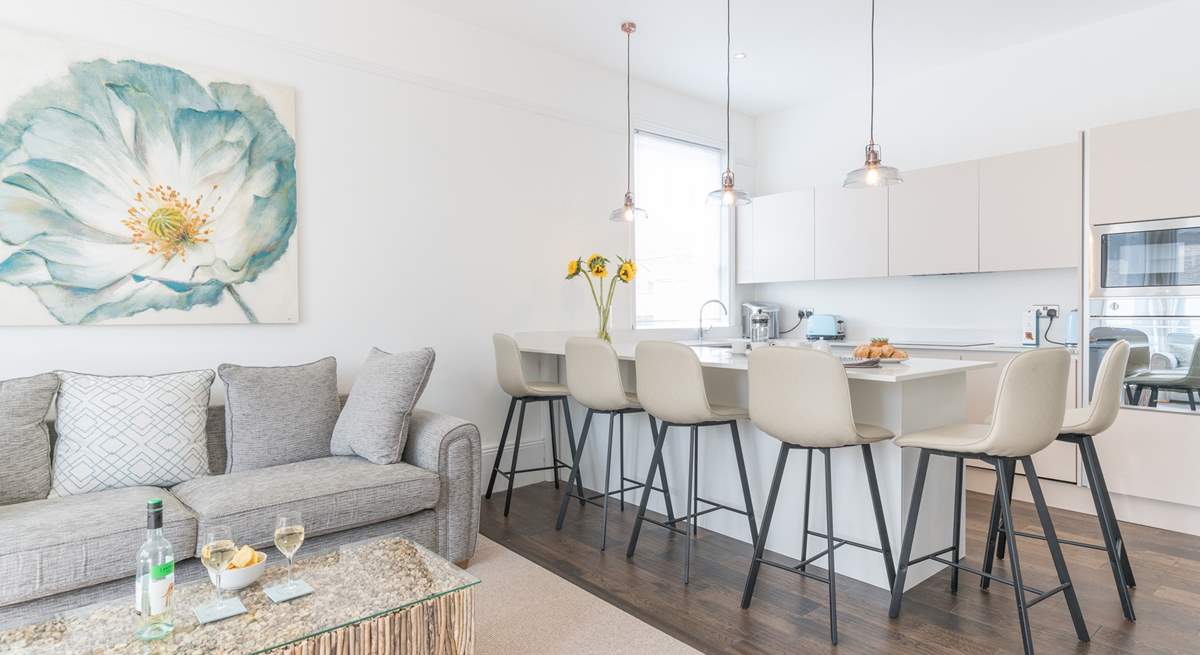 The sleek lines of the kitchen are complemented by the contemporary seating.