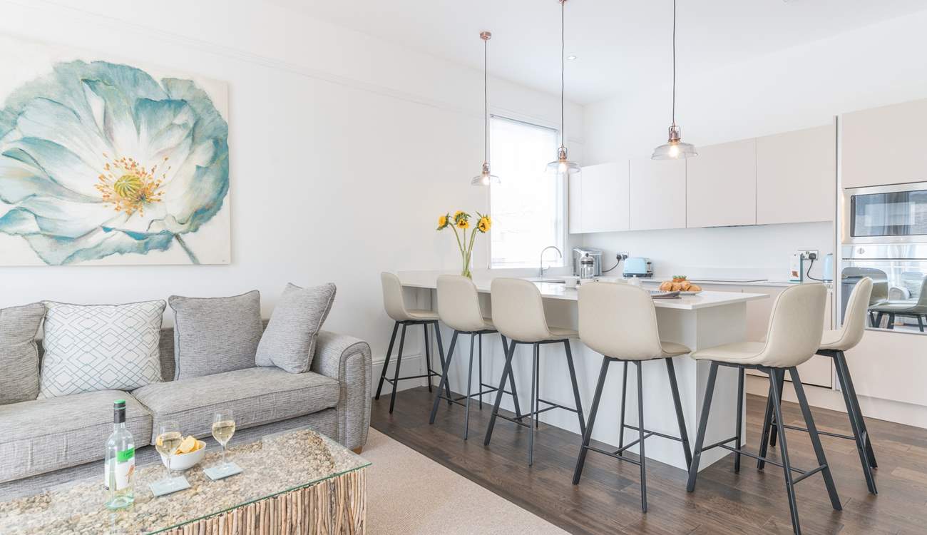 The sleek lines of the kitchen are complemented by the contemporary seating.