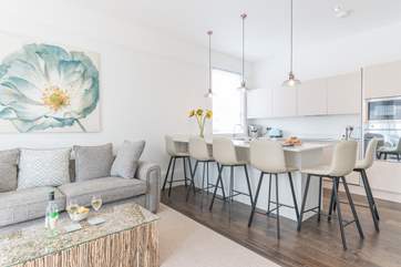 The sleek lines of the kitchen are complemented by the contemporary seating.