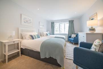 Spacious twin bedroom has been decorated with a calming feel...
