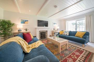 This bright and beautiful sitting-room has an open fire for the cooler months.