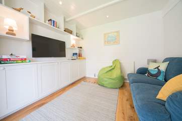 There are doors leading from both the sitting-room and playroom (providing games and books for the little ones!) to the verandah and enclosed garden to the front of the property.