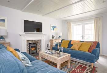 This bright and beautiful sitting-room has an open fire for the cooler months.