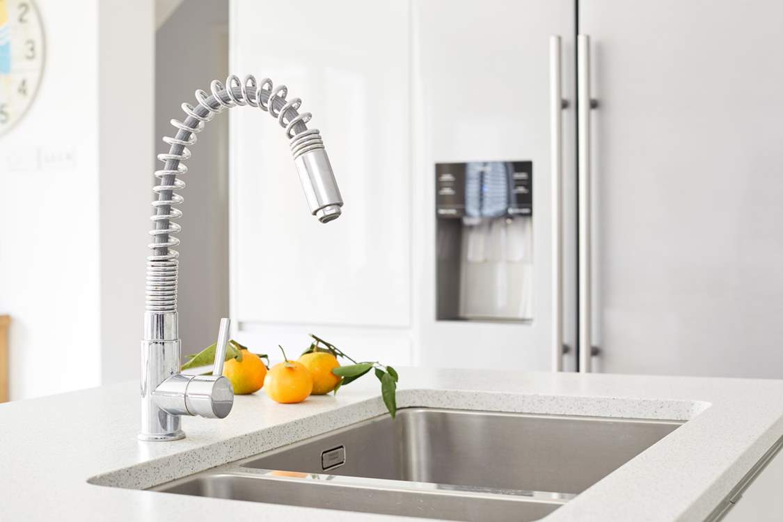 The kitchen island with large stainless steel sink.