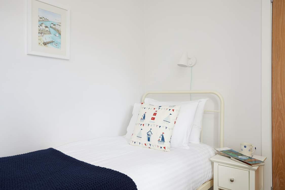 The twin bedroom with individual lighting over the beds perfect for reading.