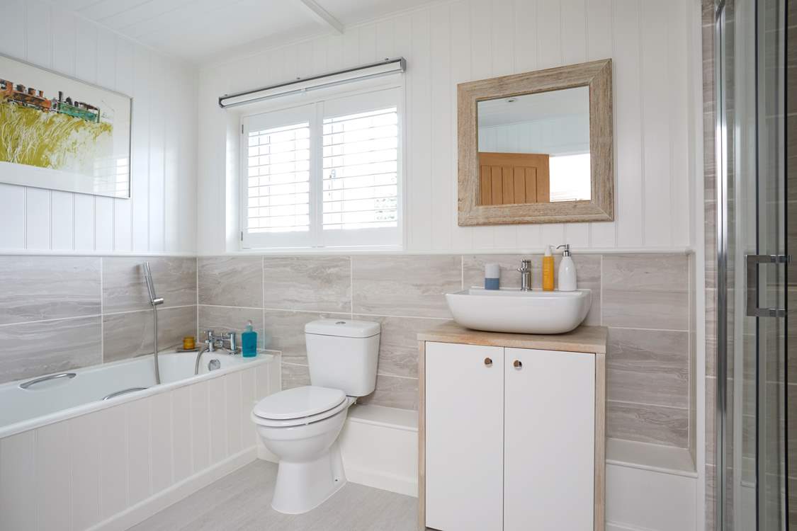 First floor family bathroom with bath and shower cubicle.