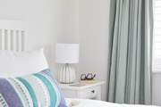 The spacious bedroom has been decorated with a calming feel...
