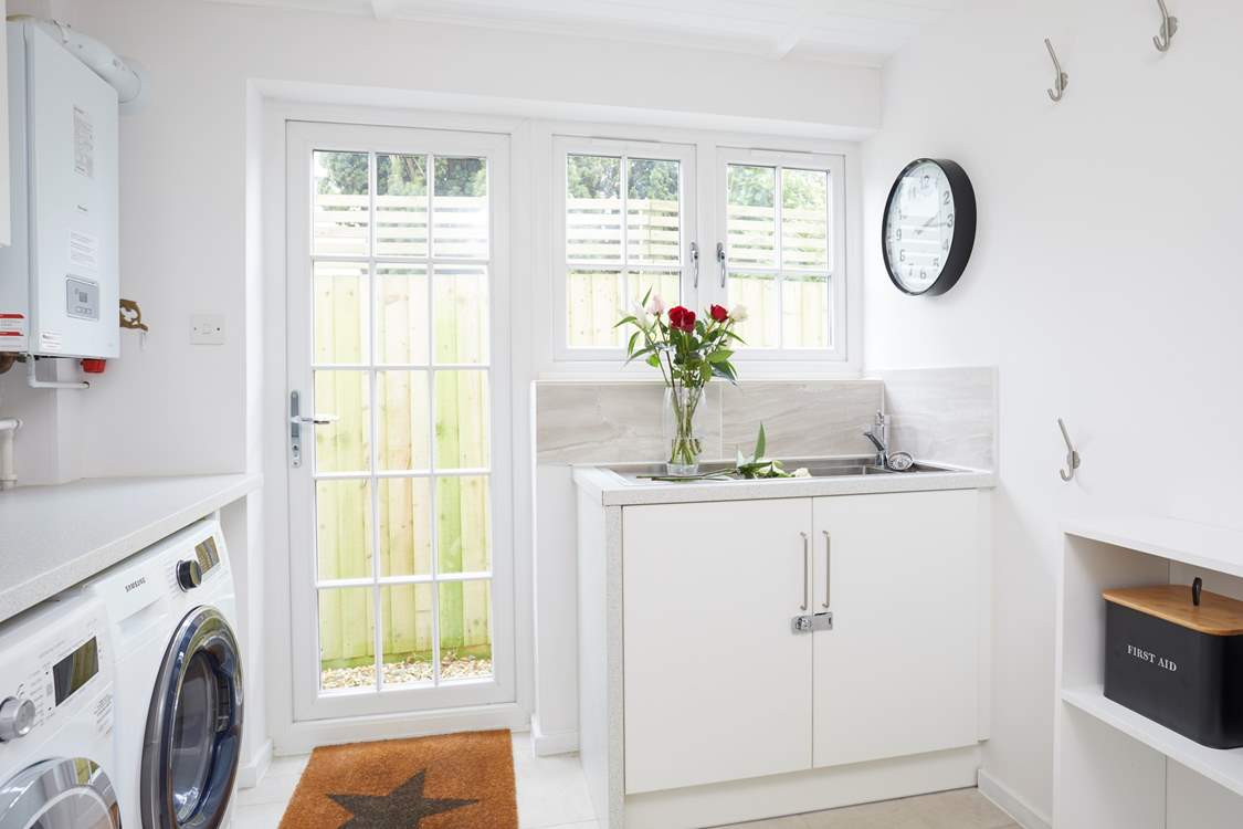 Plenty of space in the utility room and wall hooks to hang your towels from the beach.