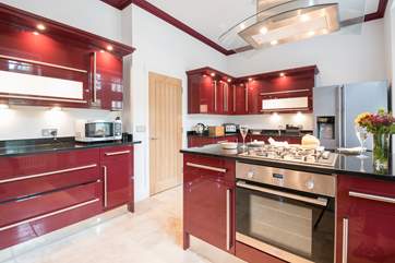 Large kitchen with American-style fridge/freezer and breakfast-bar fitted with all the equipment you could need.