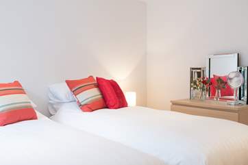 Twin bedroom, also located on the lower ground floor, with doors out to the small courtyard and external stairs to the car park.