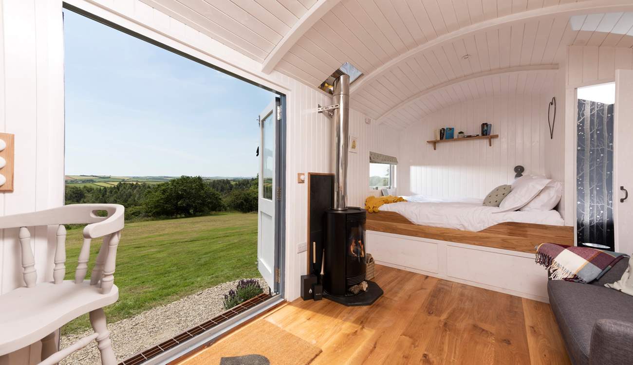 The comfy king-size bed is at the far end of the hut.