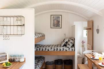 The sweet triple bunk beds are to the right of the kitchen.