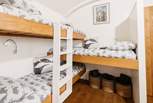 Children will love the triple bunk beds in their own sleeping area