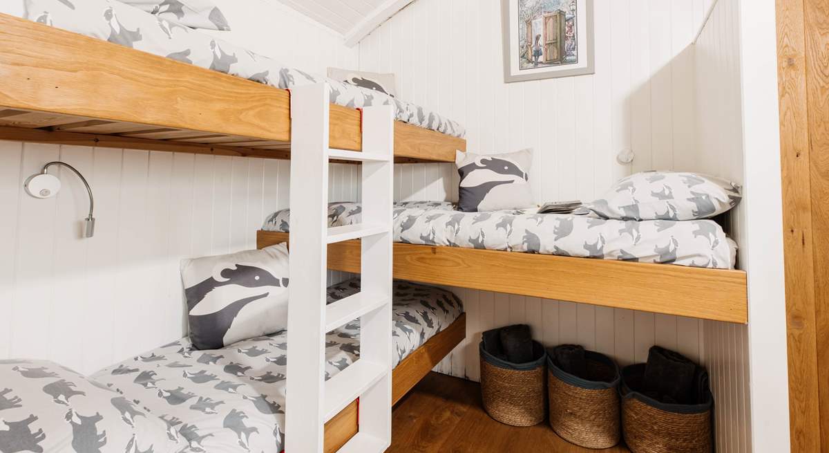 Children will love the triple bunk beds in their own sleeping area