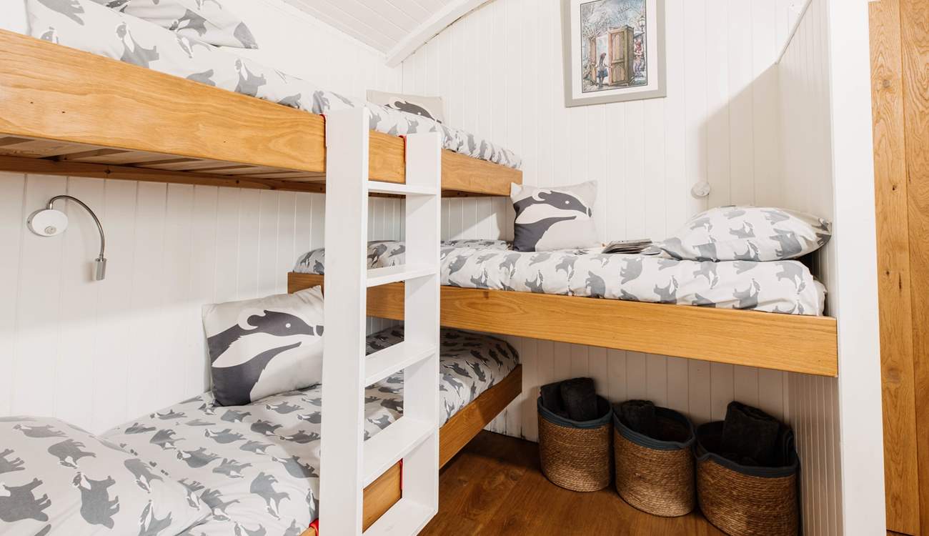 Children will love the triple bunk beds in their own sleeping area