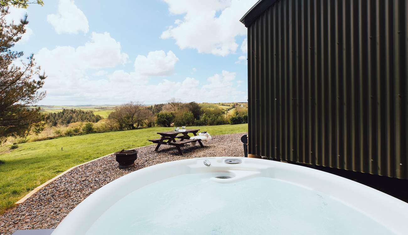 Slip into the bubbling hot tub and enjoy stunning views of rolling countryside