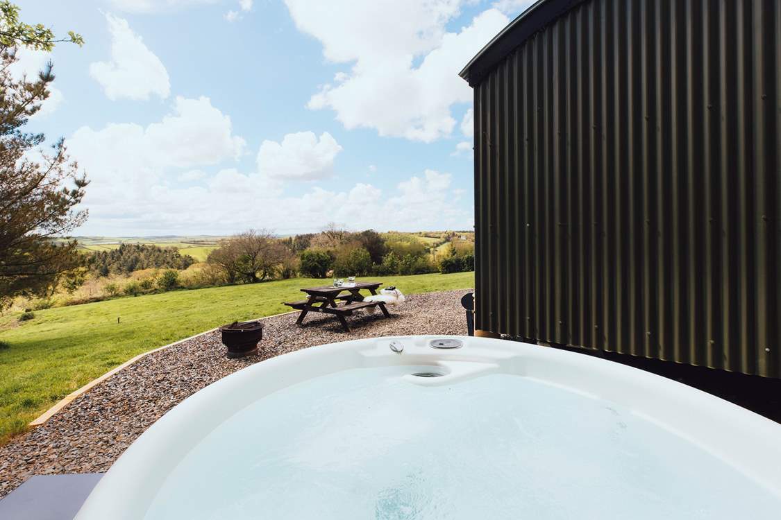 Slip into the bubbling hot tub and enjoy stunning views of rolling countryside