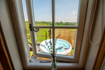 The shower-room window looks out to the hot tub, tucked around the side of the hut.