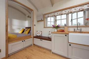 The bed is tucked away in a Scandinavian style alcove.