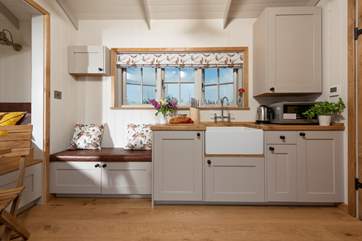 The small but well-equipped kitchen includes a deep Belfast sink, microwave, hot plate and mini fridge.