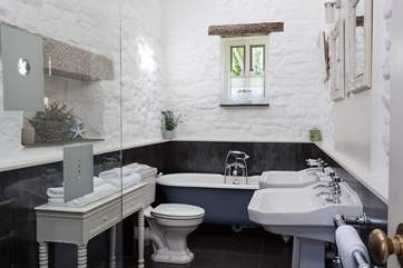 The sumptuous bathroom has a gorgeous free-standing roll-top bath, and Jack and Jill sinks.