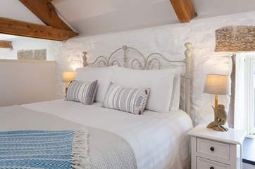 The linens and soft throws complement the bedroom beautifully.
