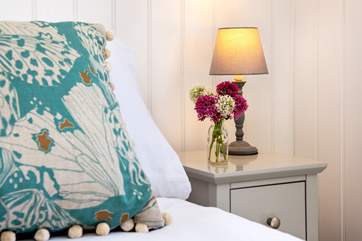 Beautiful cushions adorn the bed.